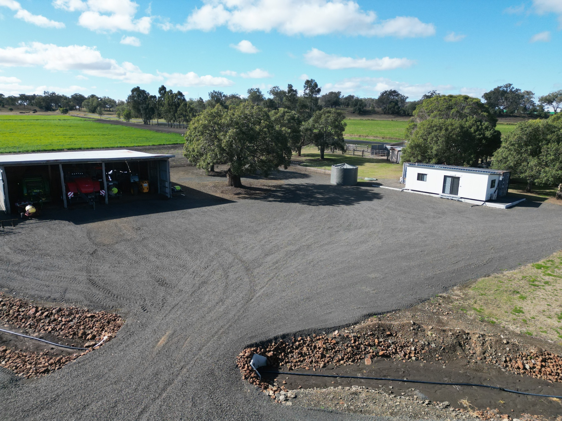 Compacted gravel hardstand around a machinery shed and dongas